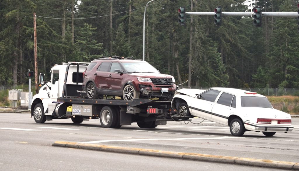 a-tow-truck-towing-a-car-on-the-road-hz-6ktzqwz0